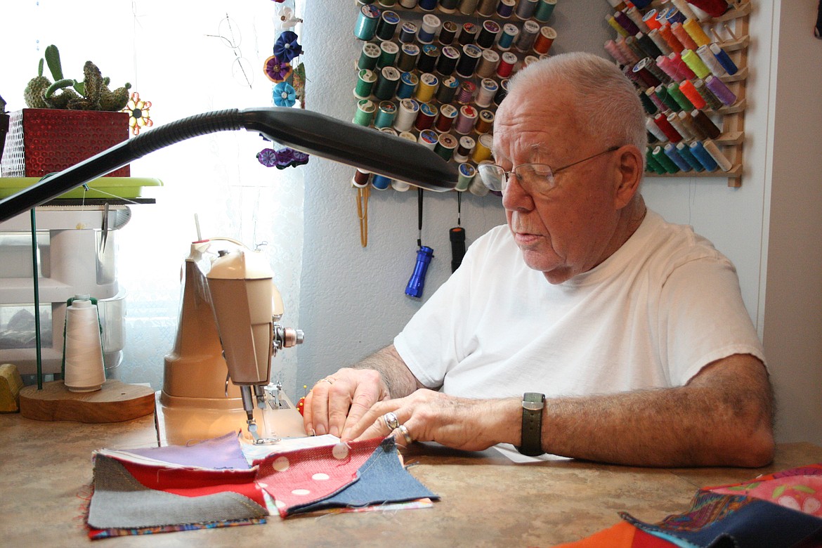 Mel Neal stitches together quilt blocks on his 1950 Singer. The vintage machines – the Neals have three of them – are the only kind they use.