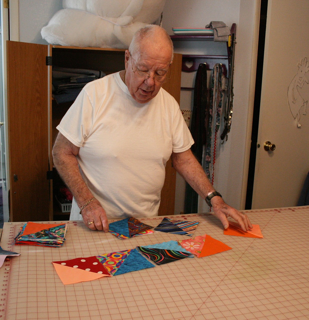 Mel Neal looks for the most pleasing quilt design. Mel and Max Neal have made more than 800 quilts for Columbia Basin Cancer Foundation patients.