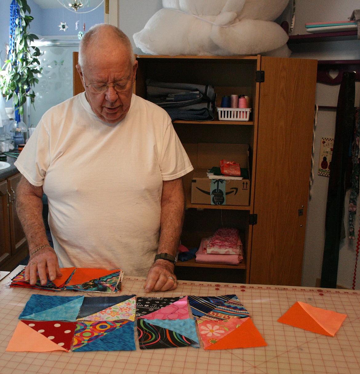 Mel Neal checks the design of a new quilt. Neal and his wife Max have made more than 800 quilts they donated to the Columbia Basin Cancer Foundation.