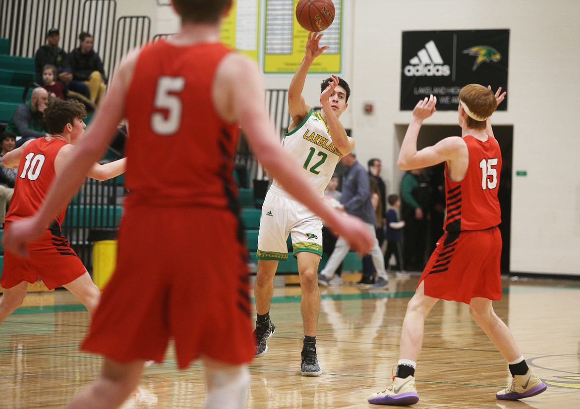 Lakeland High’s Abe Munyer passes the basketball to a teammate during Monday’s game against Sandpoint. (LOREN BENOIT/Press)