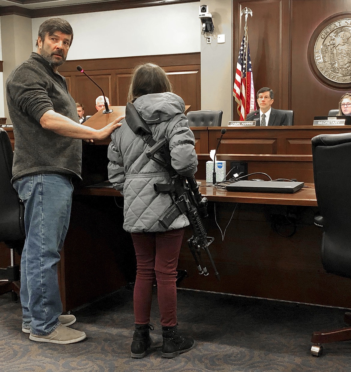 Charles Nielsen, 58, and his 11-year-old granddaughter, Bailey Nielsen, testify before a House panel at the Idaho Statehouse on Monday. Feb. 24,  in Boise. Visitors to Idaho 18 and older who can legally possess firearms would be allowed to carry a concealed handgun within city limits under legislation that headed to the House on Monday, Feb. 24.