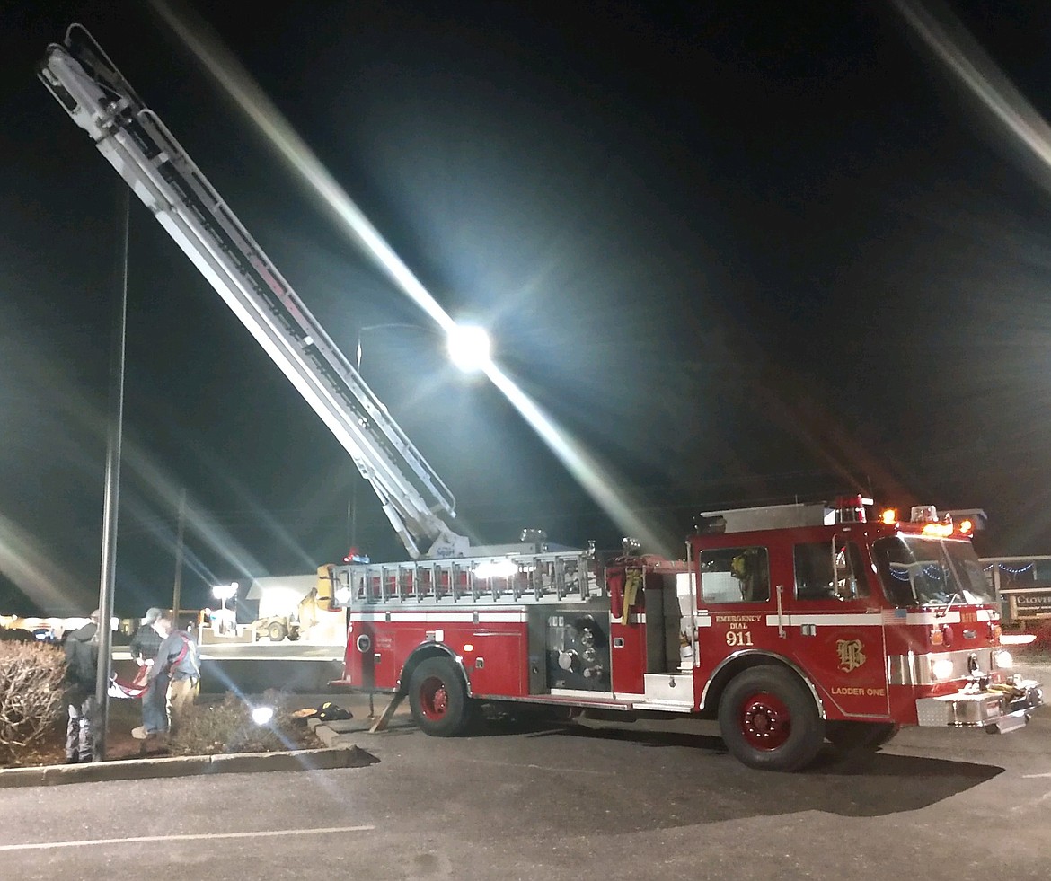 Bonners Ferry Firefighters fold the U.S. flag after rescuing it from the top of the flagpole at Wells Fargo Bank. It was seen dangling in the wind.