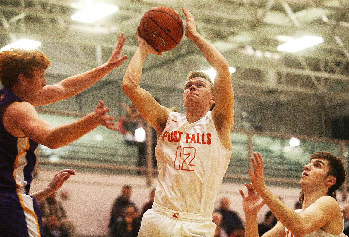 Post Falls High’s Isaac Ballew goes for a layup against Lewiston in the 5A Region 1 championship game Wednesday at The Arena.