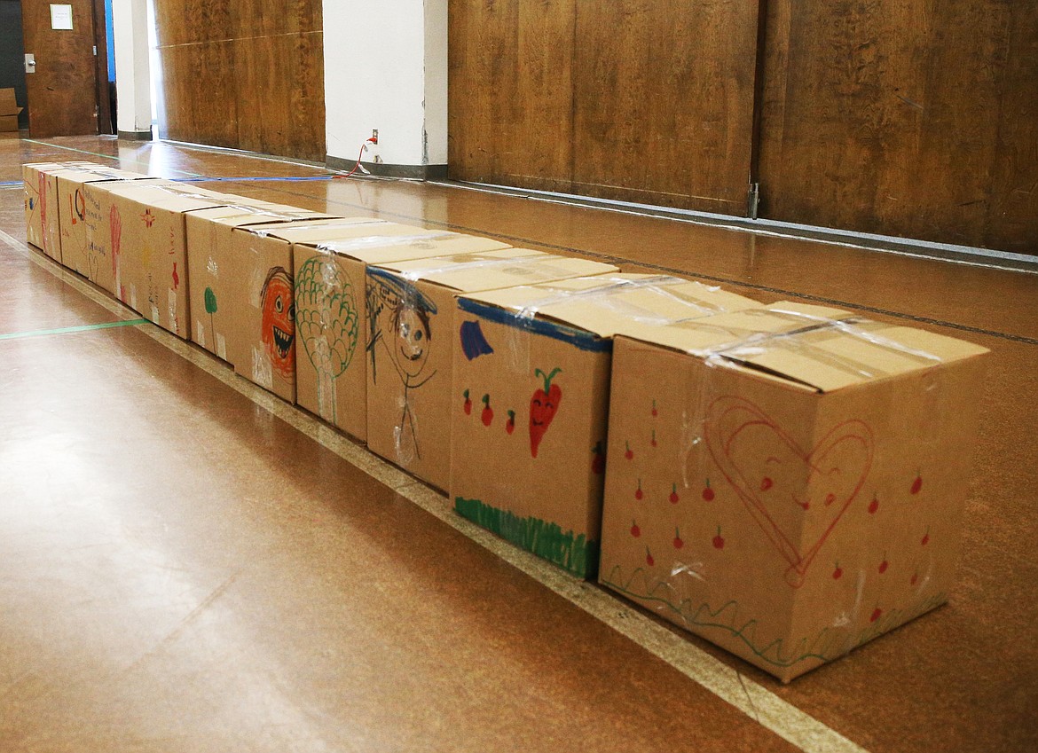 North Idaho Christian School students colored and wrote encouraging notes on boxes during the school's Feed the Need packing party.  (LOREN BENOIT/Press)