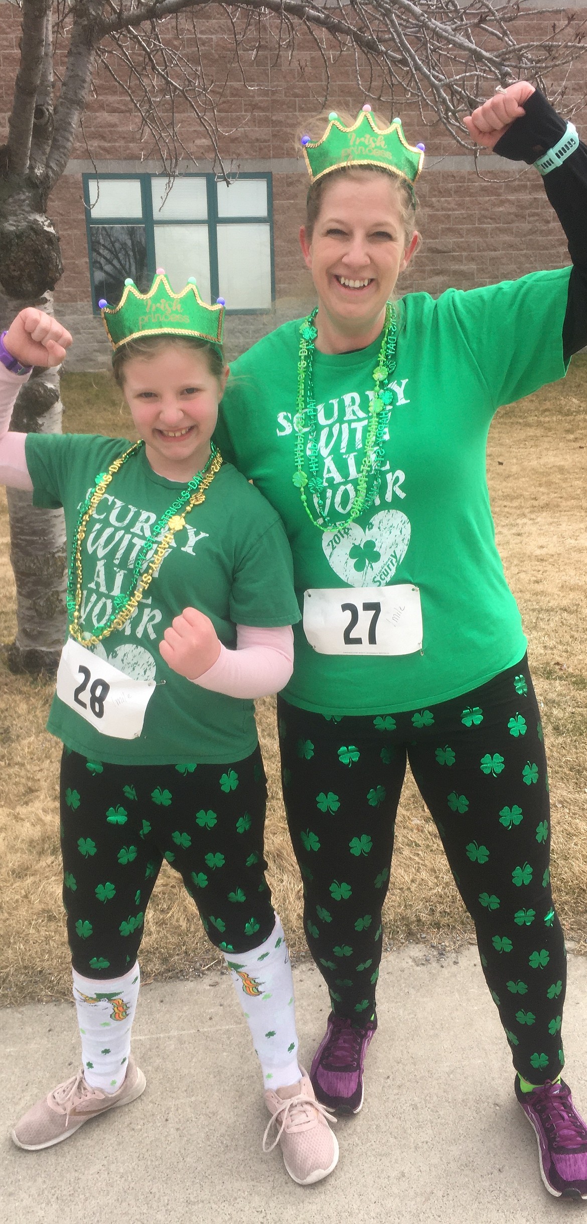 Mom Jessy Spencer and daughter Lydia Spencer, 9, of Coeur d’Alene, celebrate after finishing the Leprechaun Scurry on Saturday at Lake City High School.