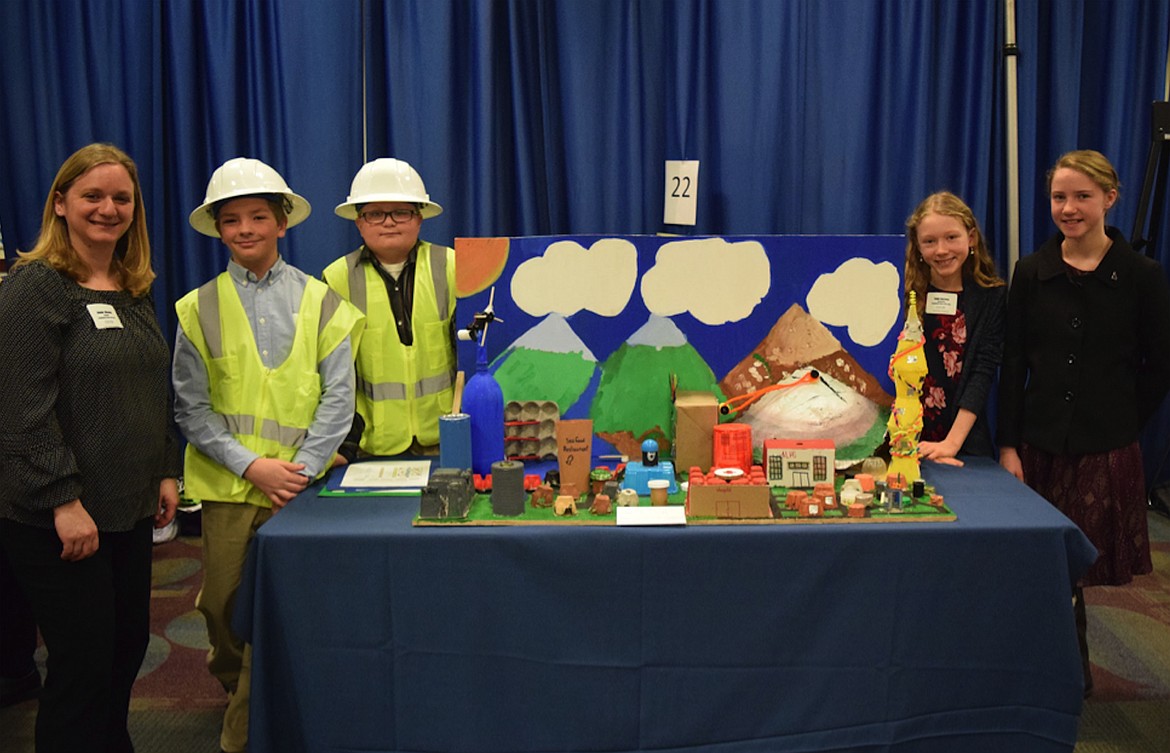 Team Aqualantis made up of Hunter Warwick, Taylor Ailport, Dakota Rief, and Taylor Burrows won the award for water design system that demonstrates potential for use in underdeveloped countries. They are pictured with Northside teacher Jeanne Warwick.