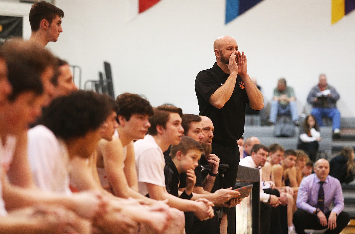 Post Falls High head coach Mike McLean shouts a play to his team during the 5A Region 1 boys basketball championship game against Lewiston last Wednesday at Post Falls High.