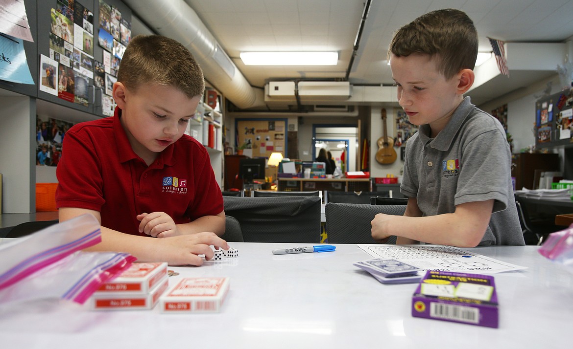 Hudson Fremouw, right, helps Bentlee Fox with his math using die during class Monday at Sorensen Magnet School of the Arts. Mathletes pairs third- through fifth-graders with first- through third-graders who need math assistance as they engage in math activities and games that are beneficial to both students. (LOREN BENOIT/Press)
