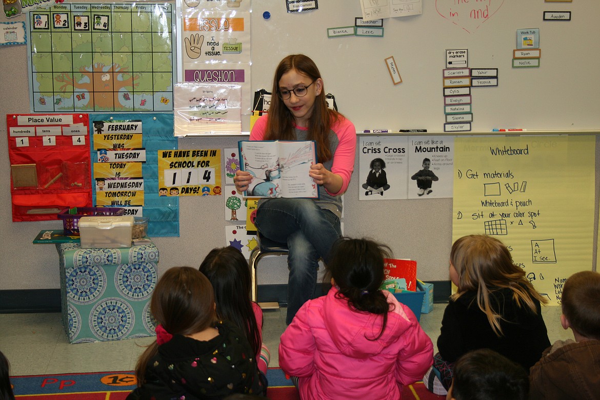 Madeline Goble, Moses Lake High School FFA, reads to Knolls Vista Elementary students during Dr. Seuss Day Wednesday.