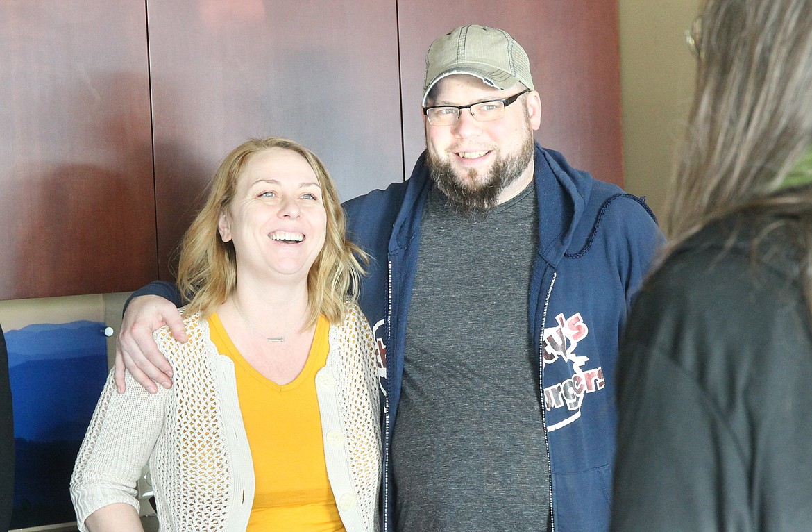 Schmidty’s Burgers owners Nathan and Denise Schmidt enjoy a light moment at Wednesday presentation of funds from Saturday’s concert by The Rub for the Jan. 20 fire victims in downtown Coeur d’Alene.