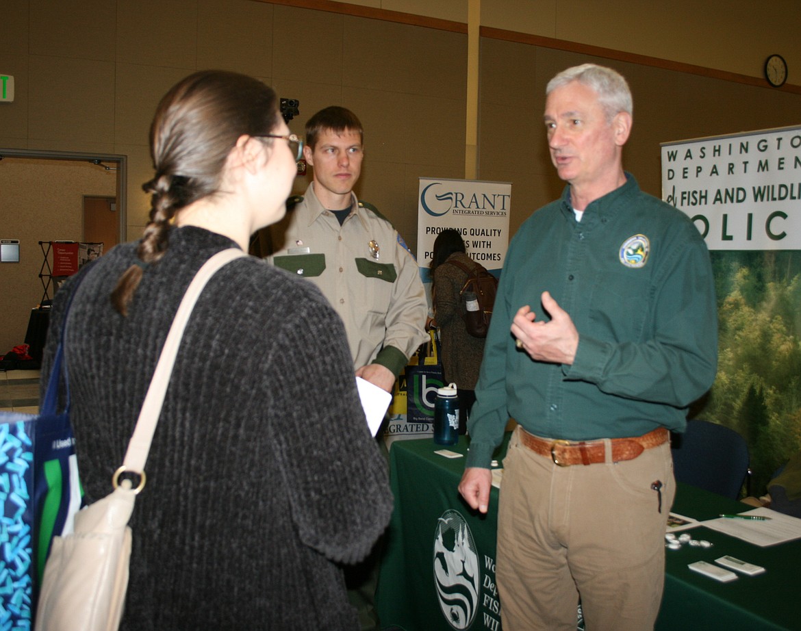 David Kalb (right) of the Washington Department Fish and Wildlife talks to prospective job seekers during the Job and Career Fair at Big Bend Community College Thursday.