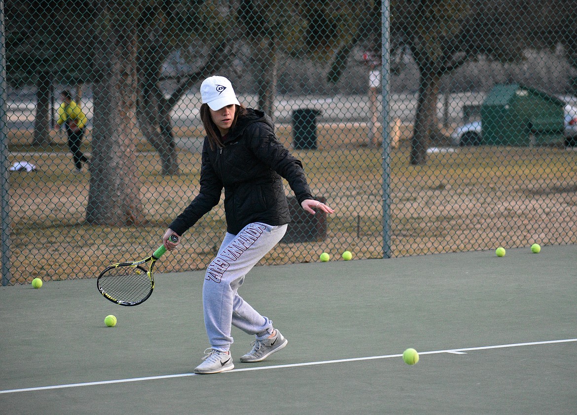 (Photo by DYLAN GREENE) 
 Senior Hadley Goodvin attempts to return a serve during a practice this year.