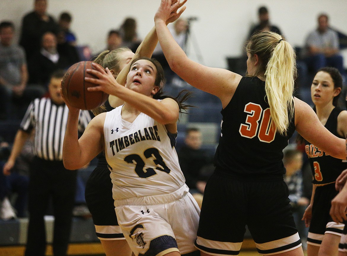 Timberlake’s Kati Bain drives to the basket around Priest River defenders in a game at Timberlake High School on Feb. 10.