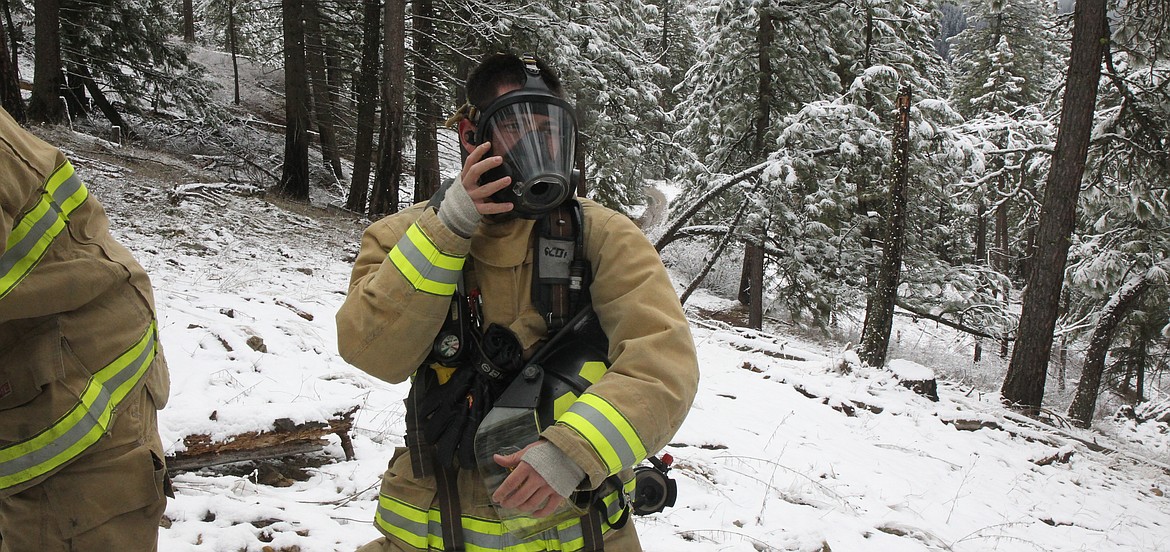 Coeur d’Alene firefighter Neko Caballero removes his mask after finishing a 1.3-mile trek with a 900-foot elevation gain up Canfield Mountain.