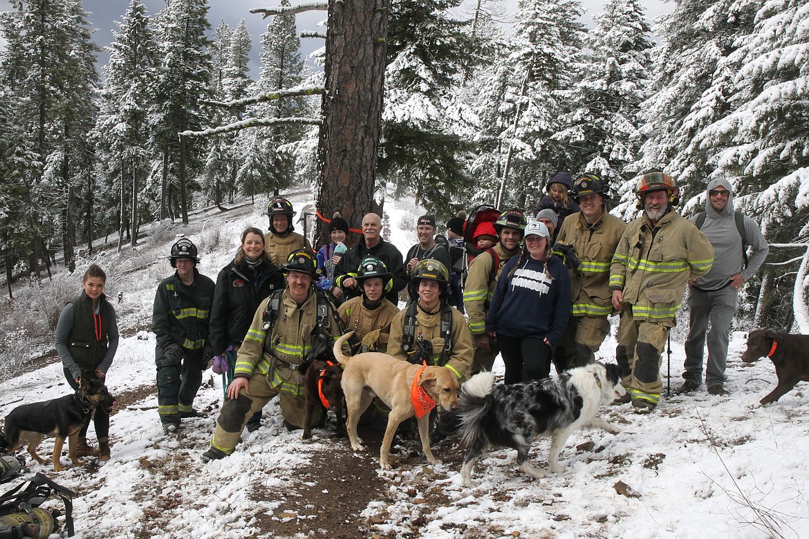 BILL BULEY/Press 
 North Idaho firefighters, family and friends, along with canines, gather for a photo after reaching their goal on Canfield Mountain Sunday morning.