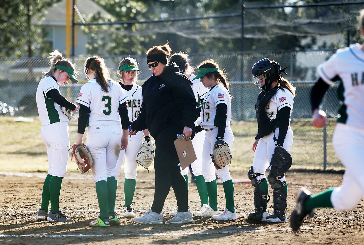 Lakeland High School head softball coach Colleen Bevacqua and players gather in the circle during a pitching change Thursday.