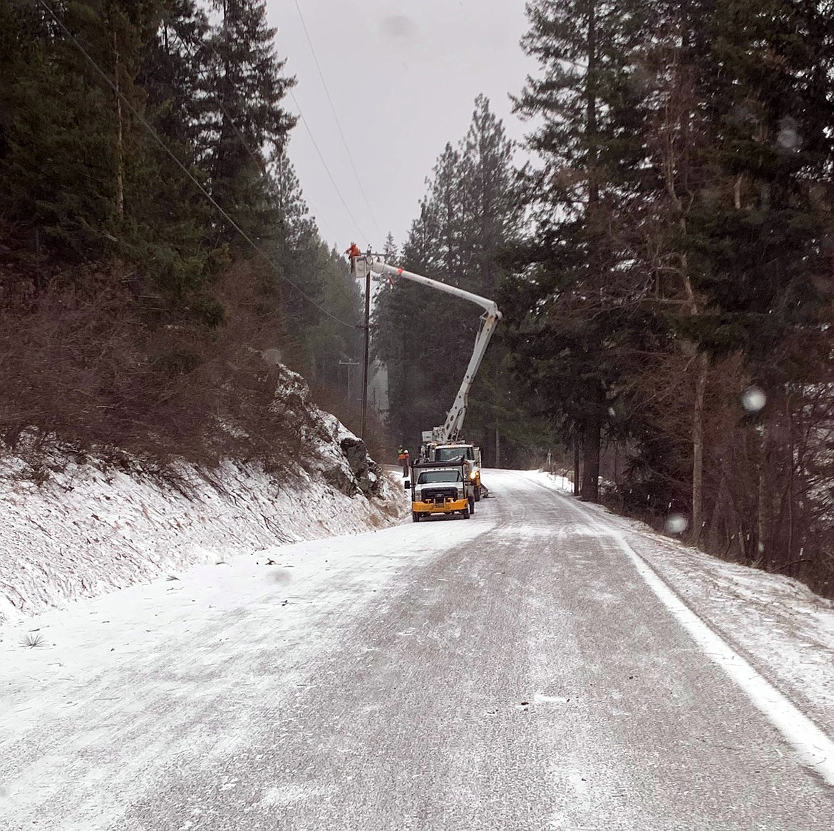 (Photo courtesy LAURA McKAY) 
 Avista crews work to restore power in the Bottle Bay Road area in Sagle.