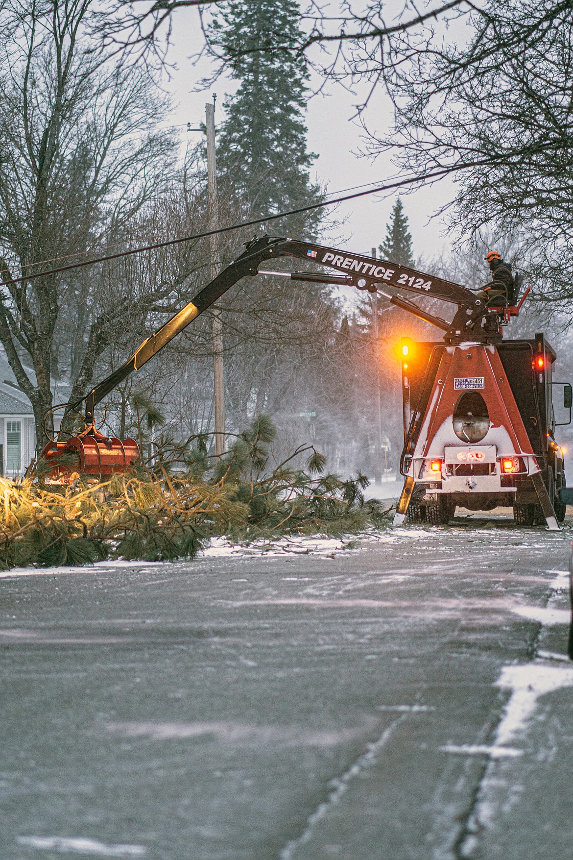 (Photo courtesy BRANDON PUCKETT/PUCKTOGRAPHY.COM) 
 Crews work to clean up the debris from a tree in the city of Sandpoint that was knocked down by a massive windstorm which struck the region.