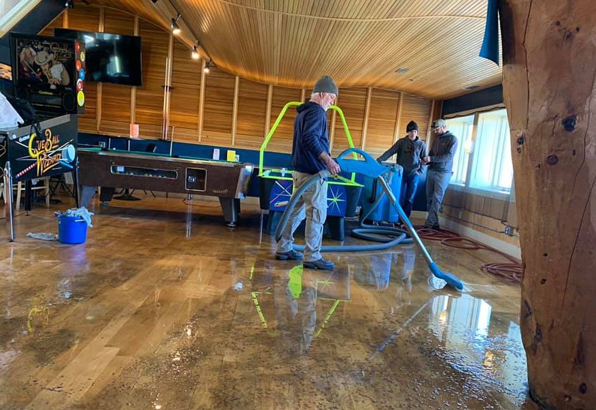 North Idaho Flood and Fire clean up the water after pipes above Coins Arcade in the Cedar Street Bridge burst Sunday afternoon.