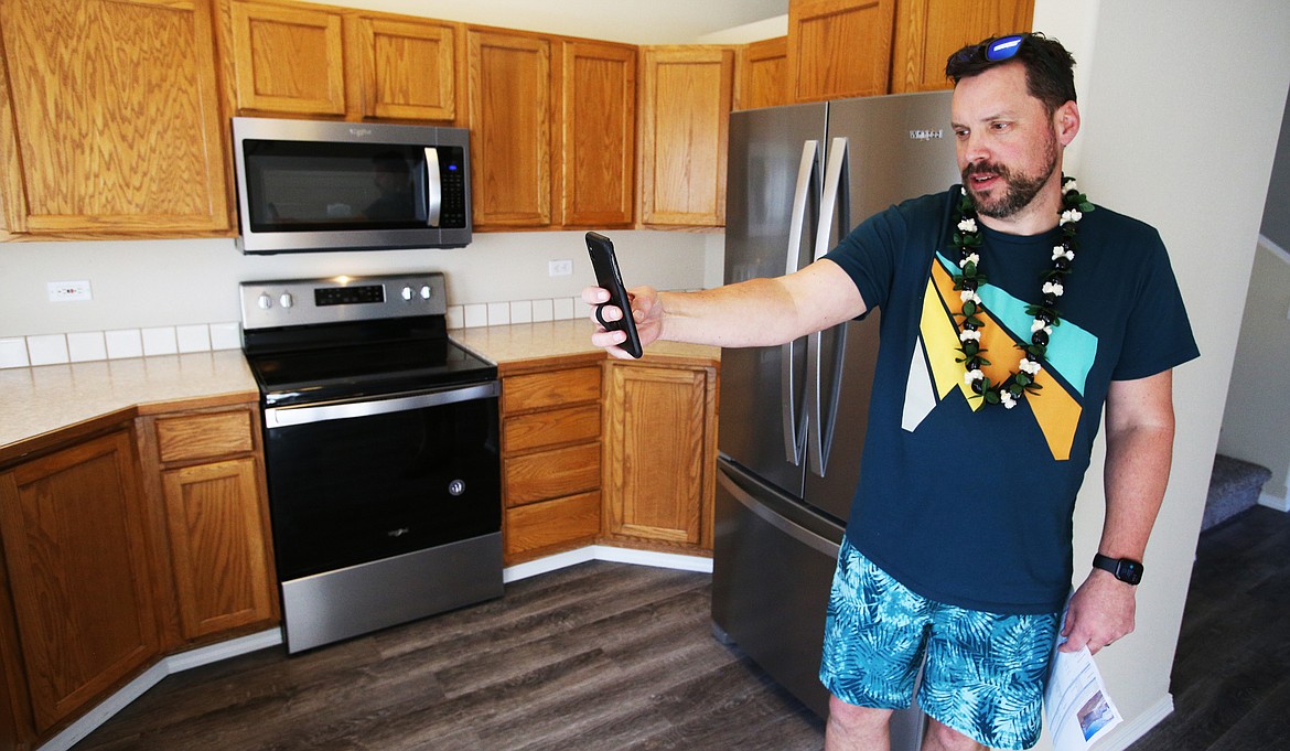 The coronavirus has slowed down real estate, but many agents, like John Thomas Sinclair, are offering virtual tours for potential buyers. Here he records a live video of a house on Morleau Lane in Coeur d’Alene. The Realtor wore Hawaiian garb as small consolation for having to cancel his romantic trip to Maui with his wife because of the spread of the coronavirus. “It was the first time we were going to take a vacation,” Sinclair said. “The first time it’s just her and I without our eight kids.”