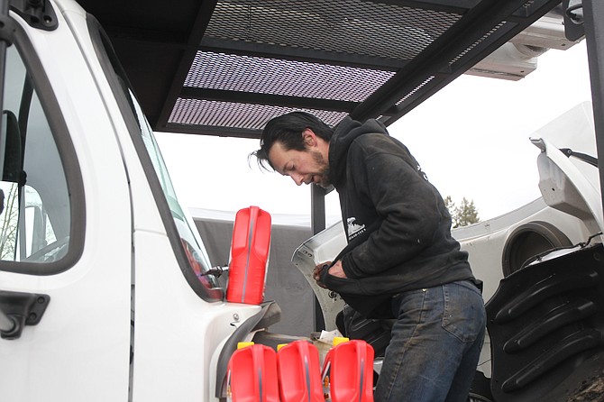 Brian Peirano tries to briefly warm his hands as he maintains a tree service truck during a frigid February day. The eight-year worker at Don Taylor Tree Service said the last winter months are financially some of the hardest for employees and owners alike.