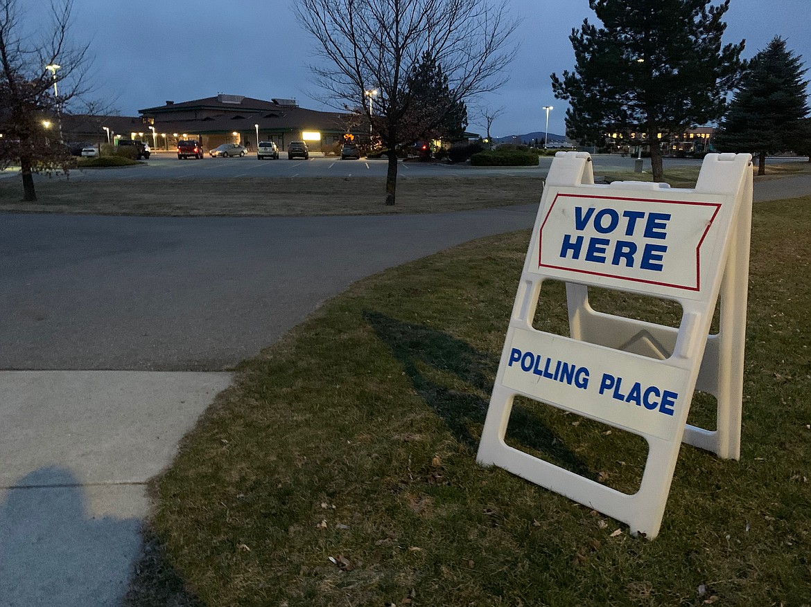 A sign directs voters inside for precinct 18 outside of Atlas Elementary where Beverly Guenette was placed on March 10. (ELENA JOHNSON)