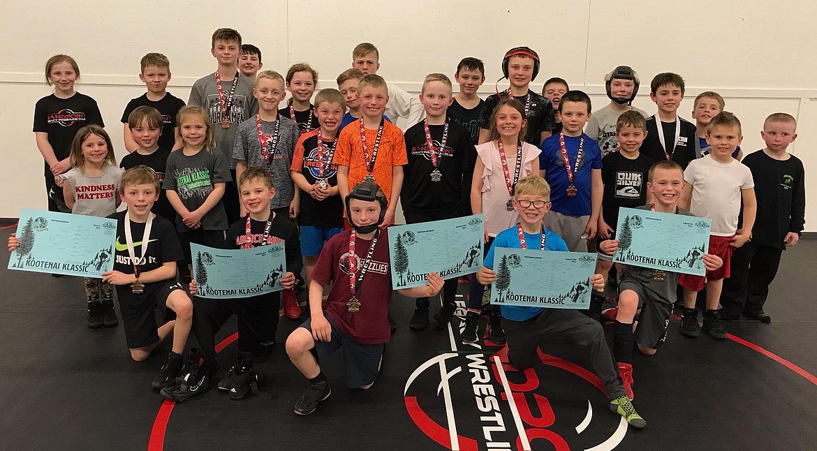 The Sandpoint Legacy team shows off their hardware from the Kootenai Klassic Tournament. Fifteen of the 21 wrestlers earned a medal in the last tournament of the team’s shortened season.