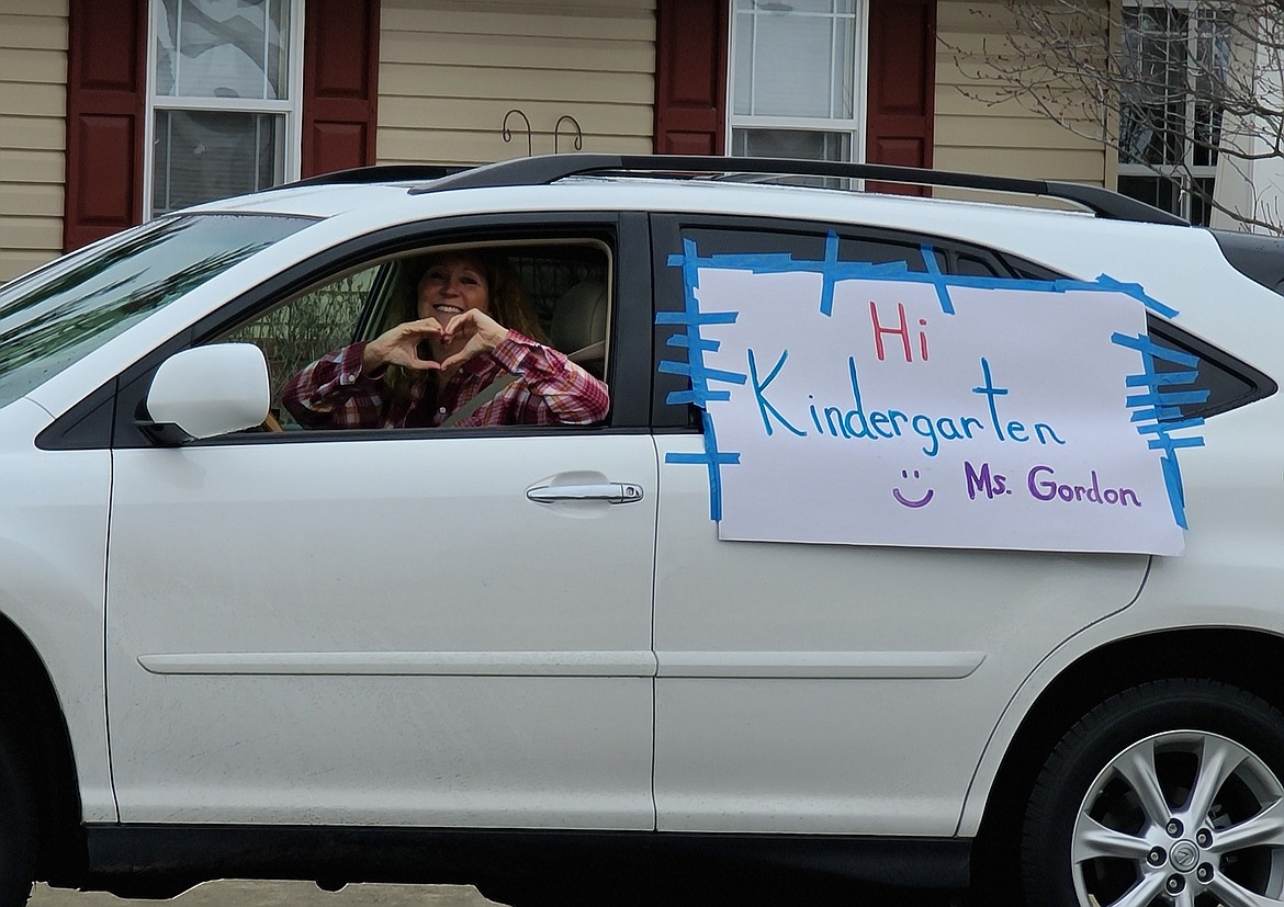 Laura Gordon has nothing but love for her kindergarten students at Atlas Elementary during a car parade Wednesday.