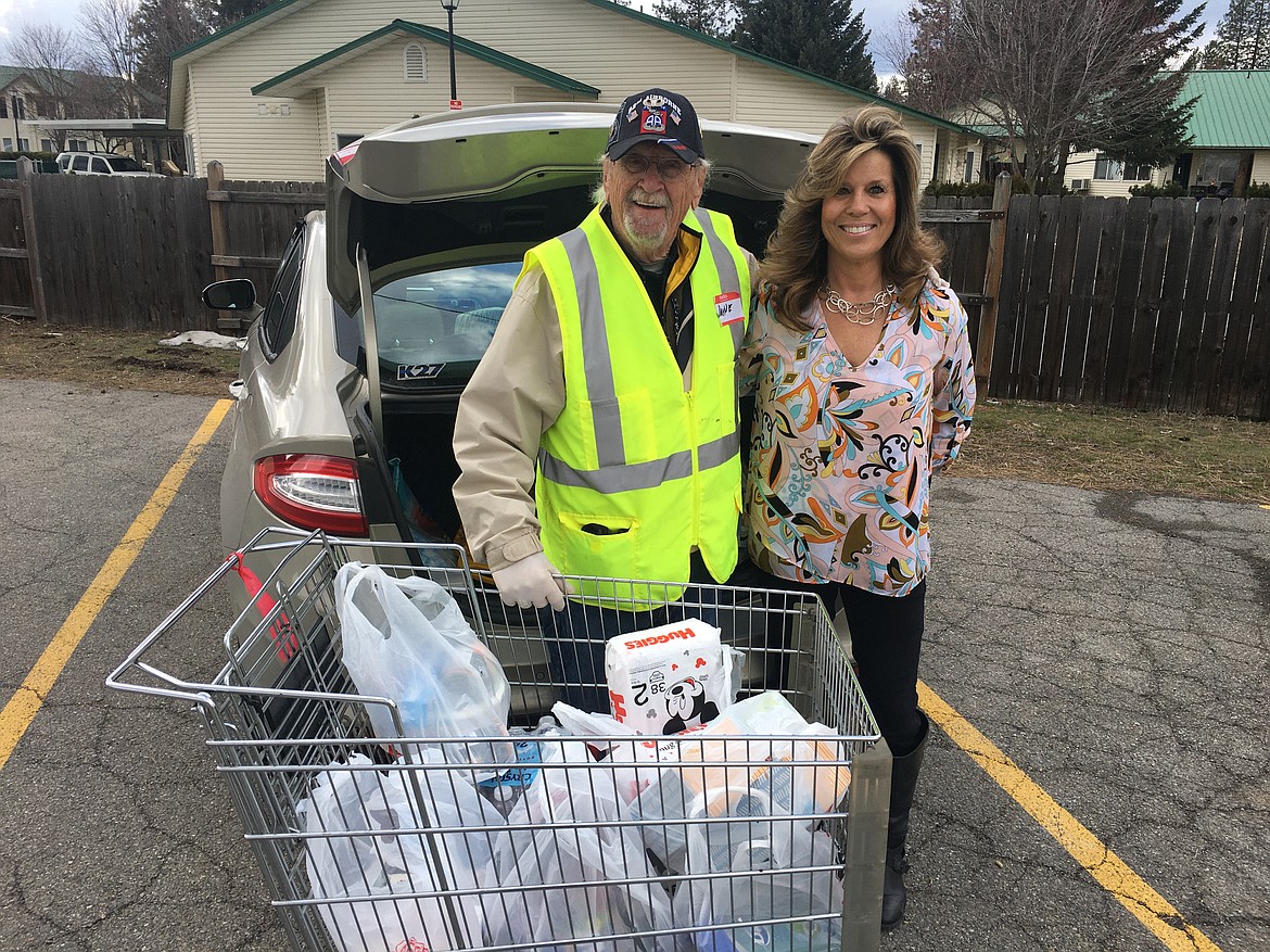 BILL BULEY/Press 
 Wayne Brewer takes a break to pose for a photo Christine French-Drube, executive director of the Rathdrum Chamber of Commerce, as she drops off donations on Thursday at the Rathdrum Senior Center.