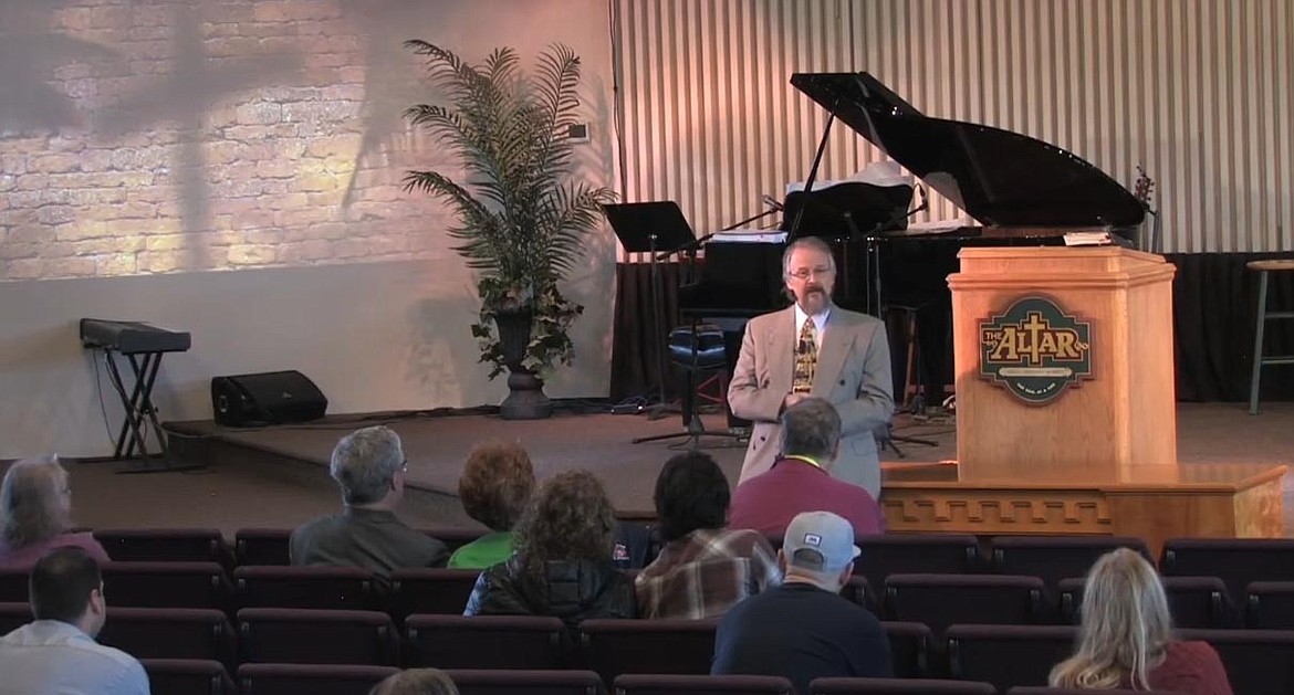 Screen grab from YouTube 
 Pastor Tim Remington speaks to a sparse crowd last Sunday at The Altar Church in Coeur d'Alene, defying the governor's stay-home order.