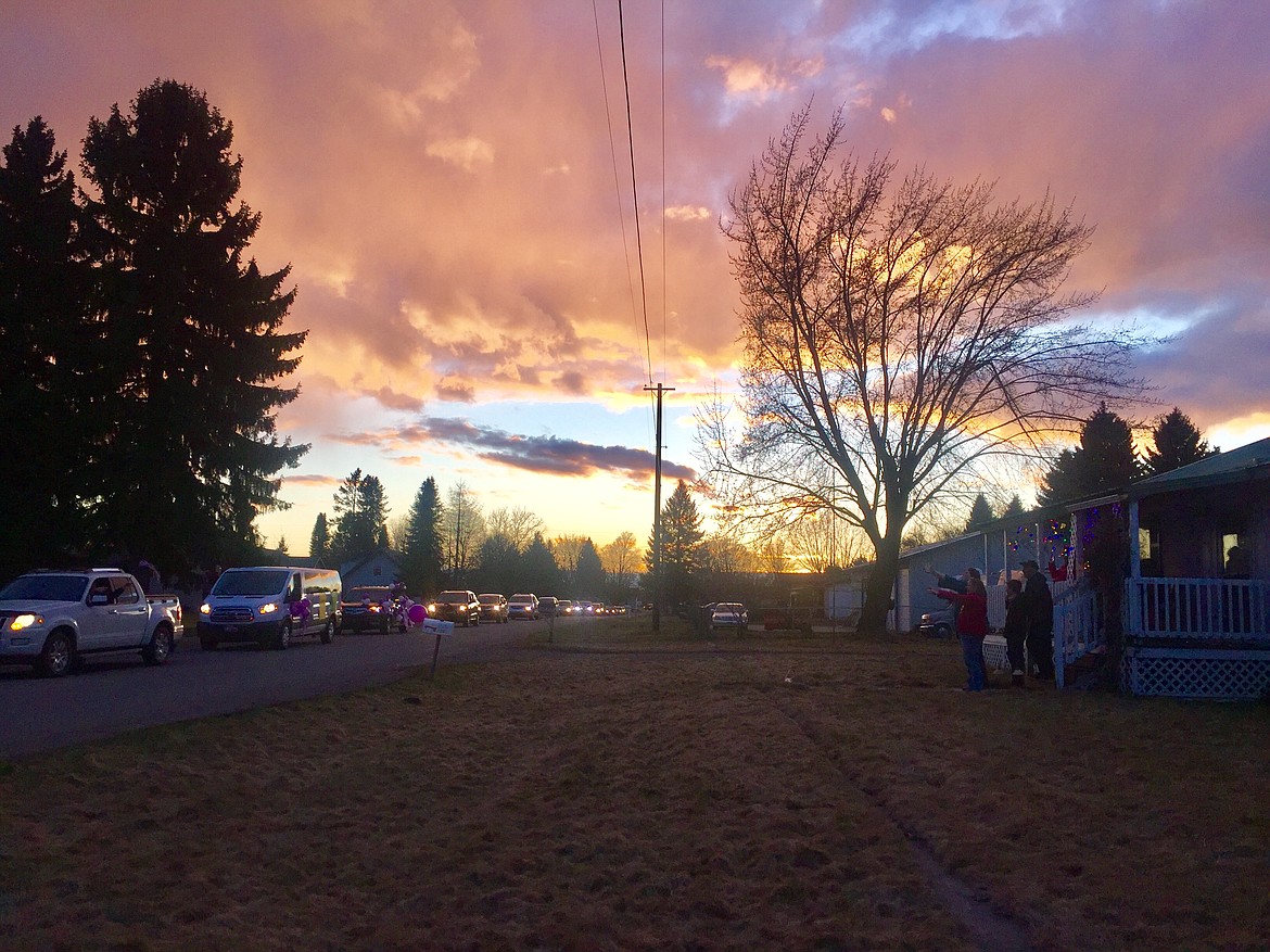 Over 100 cars drive past the Bray home to pay their respects to the family Thursday. The family was unable to organize a funeral for Tammy Bray due to state-wide restrictions on gatherings, so the community found a way to celebrate her life. (JENNIFER/PASSARO Press)