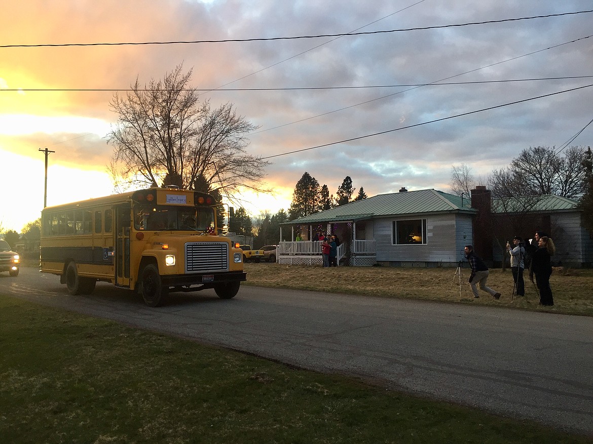 Eric English, with English Funeral Home, sets up a camera to record the procession in honor of Tammy Bray as the old school bus from Lighthouse Christian School rumbles past. (JENNIFER/PASSARO Press)