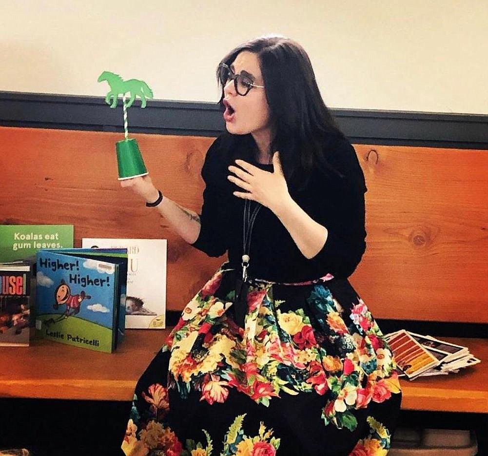 Youth services librarian “Miss Mandi” Harris reads a book during story time at the Coeur d’Alene Carousel last summer. Harris and the Coeur d’Alene Library are providing several online options to keep kids busy during spring break and school closures.