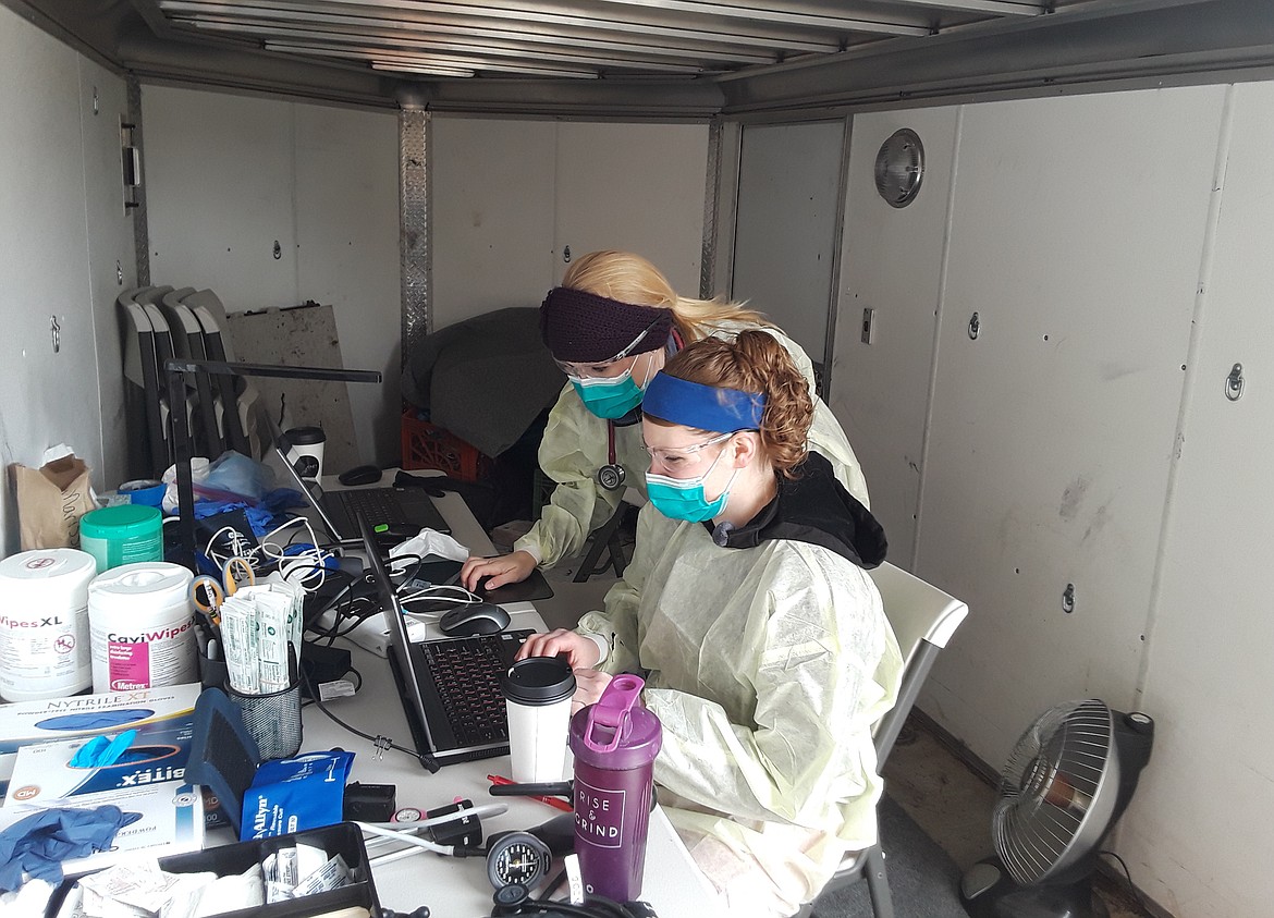 Nurse practitioner Jeanna Padilla (back) and nurse Marissa Vandaveer work in a trailer-turned-makeshift nurses station behind Coeur d’Alene Pediatrics’ Hayden office. The Hess Street location has been converted to a drive-in clinic to treat children who have fallen ill to colds, influenza, strep and other illnesses.
The Coeur d’Alene and Post Falls sites will remain ‘clean’ clinics while the Hayden unit treats kids who’ve fallen ill during the coronavirus crisis.