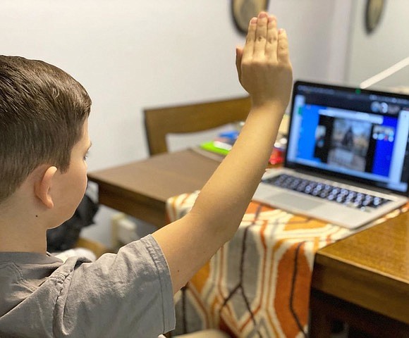 Anderson Smoot raisies his hand to be called on during an online education experience. Coeur d'Alene School District is launching "Remote Learning" today. (Photo courtesy of Innovation Collective)