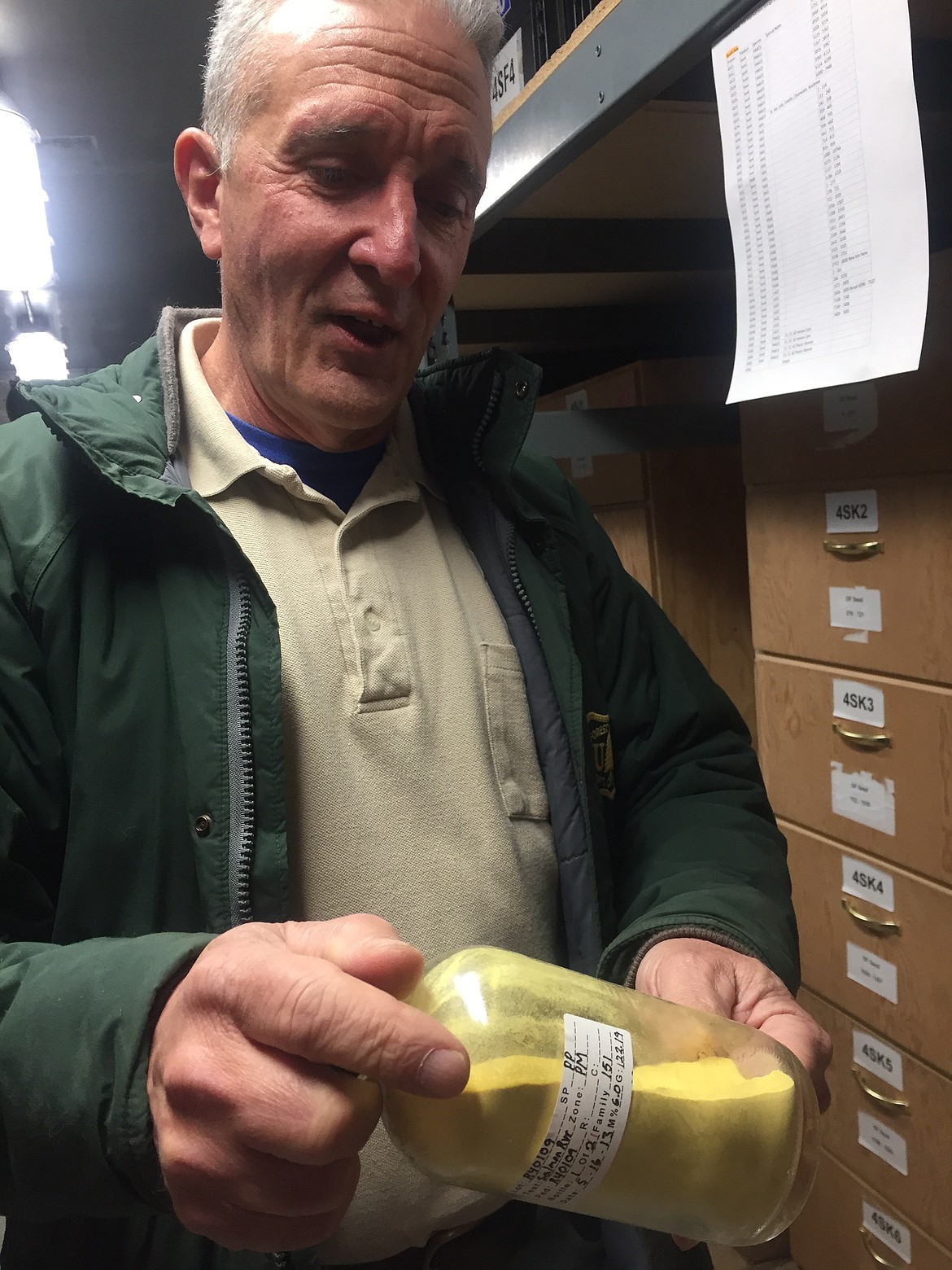 Aram Eramian turns a jar of pine pollen in the freezer at the Idaho Panhandle National Forests nursery where he is superintendent. The pollen is used to cross-fertilize disease resistant conifer seedlings. (JENNIFER PASSARO/Press)