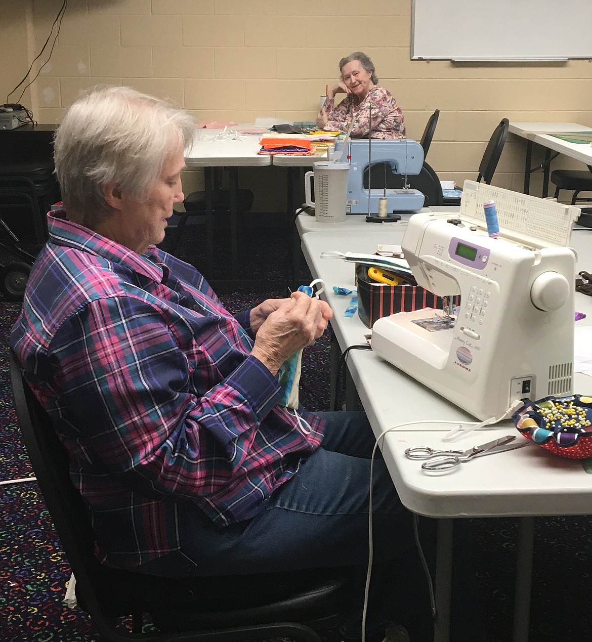 Judy Edwards, left, and Donna Gerling cut and sew fabric masks at Orchard Ridge Senior Living in Coeur d’Alene. (Courtesy photo)