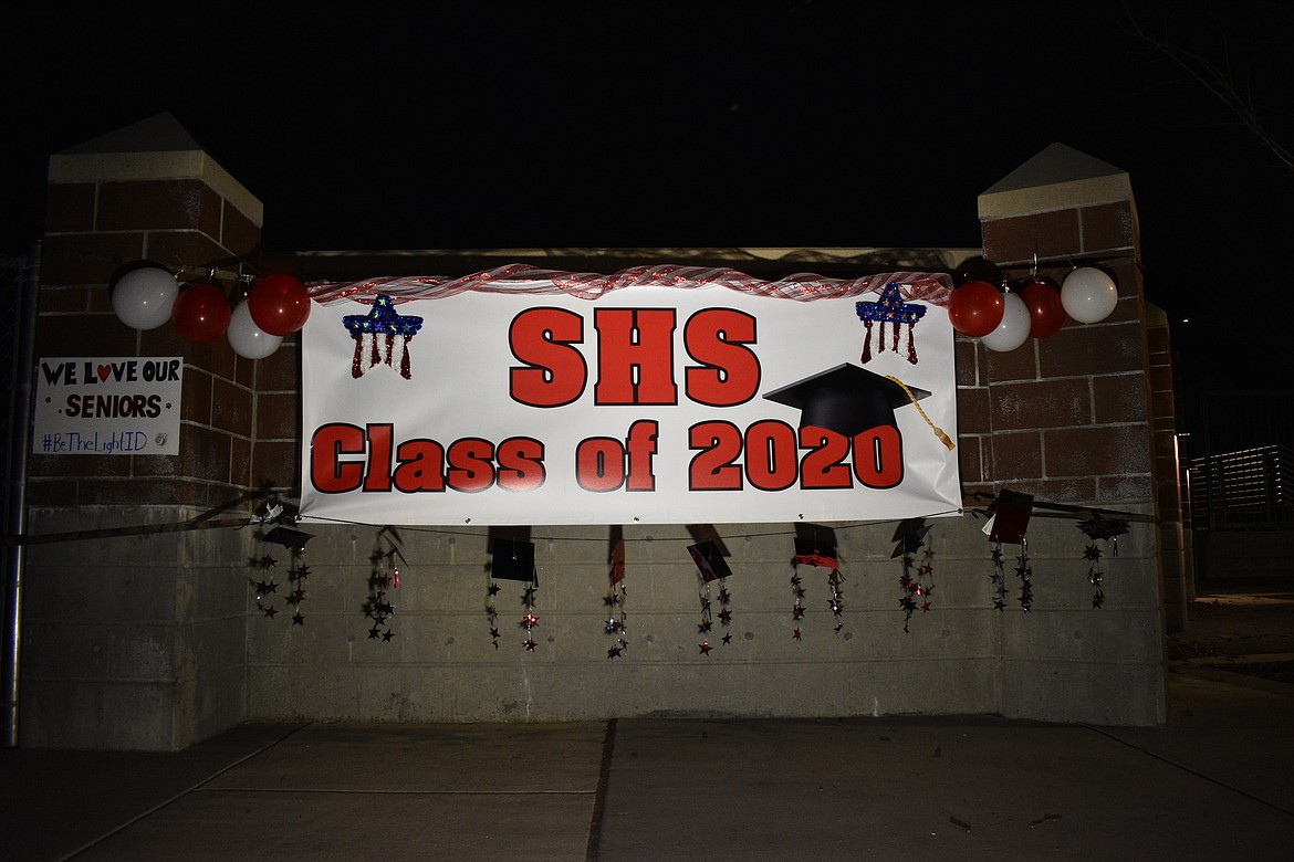 (Photo by DYLAN GREENE) 
 This banner was hung up on the wall outside the entrance to War Memorial Field. Seniors stopped to take photos with the banner created by Illustrated Business Card and Sign.