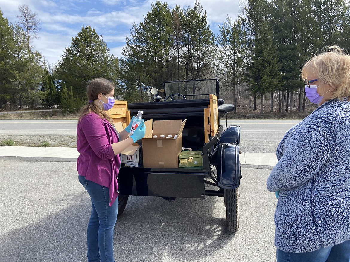 (Photo by CAROLINE LOBSINGER)
Jessie Vachon, left, gets a bottle of Mill Town’s First Response hand sanitzer ready for a customer.