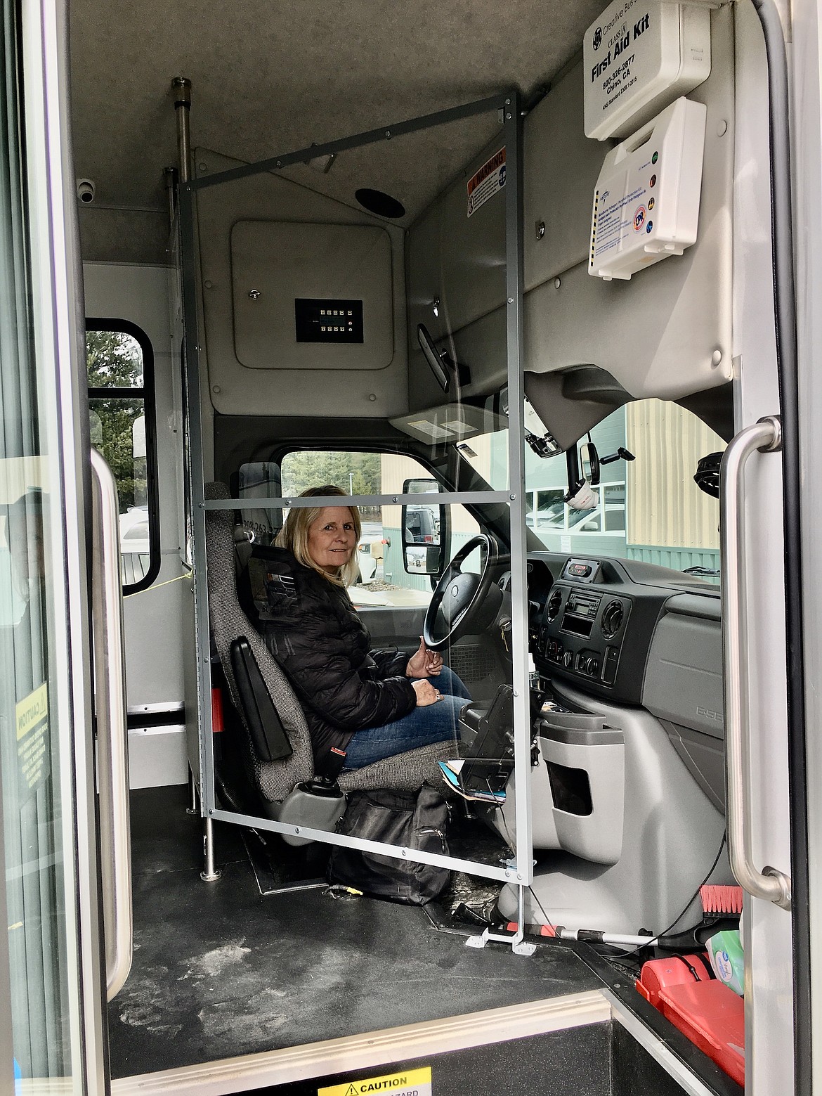 (Photo courtesy DAVE SIMS) 
 Shannon Pittman looks through the Plexiglas sneeze guard from the driver’s seat. She is SPOT’s assistant director.