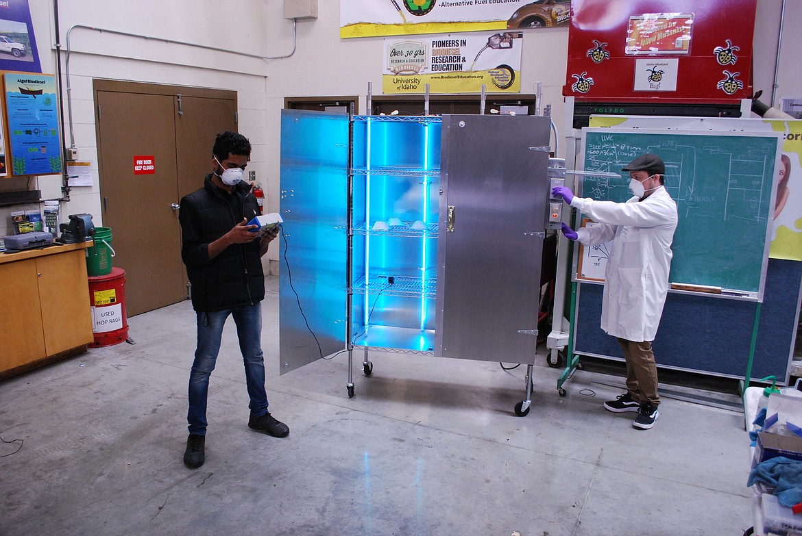 (Photo courtesy UNIVERSITY OF IDAHO COLLEGE OF ENGINEERING) 
 University of Idaho Engineering Department members, including Sandpoint native Chad Dunkel, right, check the results from testing a one-of-a-kind mobile sanitation cabinet created by the university and now in use at St. Joseph's Medical Center.