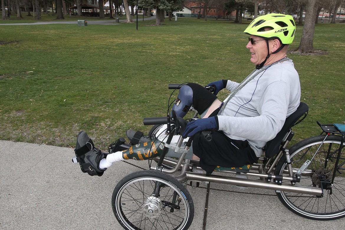 BILL BULEY/Press 
 Charlie Hughes rides his recument bike through Coeur d'Alene City Park.