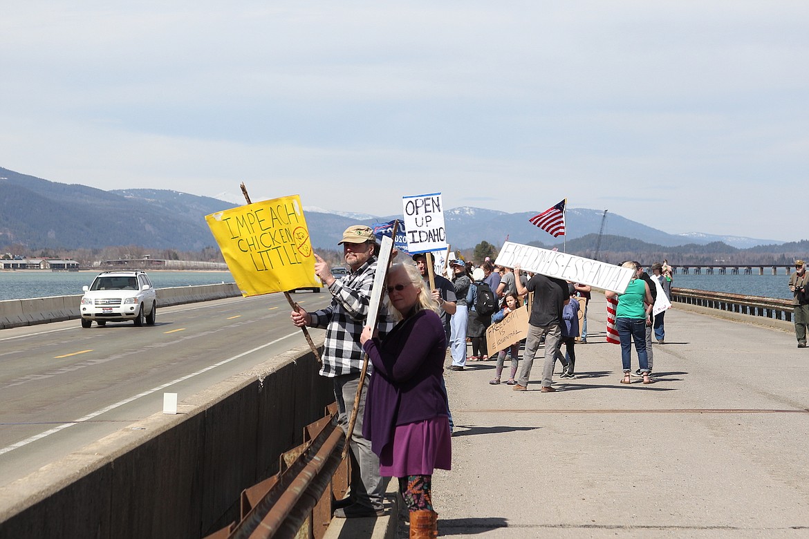 KEITH KINNAIRD/Hagadone News Network
Protesters of Idaho’s stay-at-home order walk across the Long Bridge in Sandpoint on Friday.