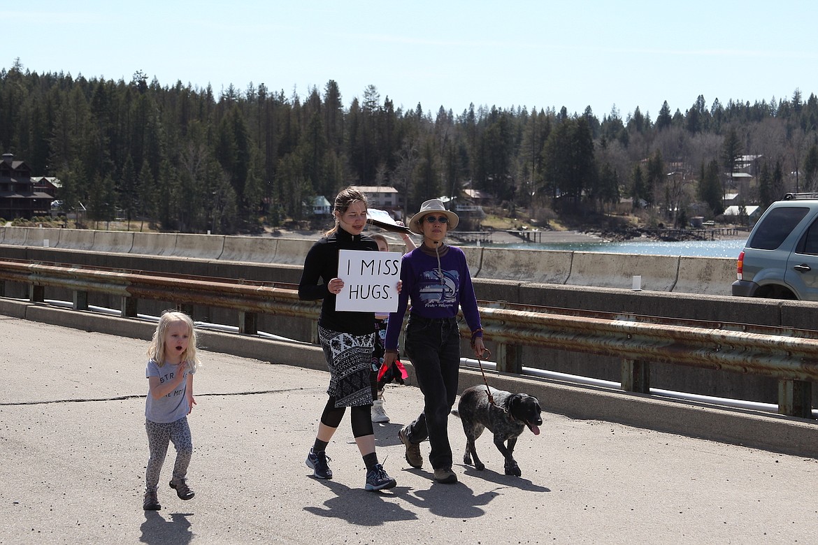 KEITH KINNAIRD/Hagadone News Network
Protesters of Idaho’s stay-at-home order walk across the Long Bridge in Sandpoint on Friday.