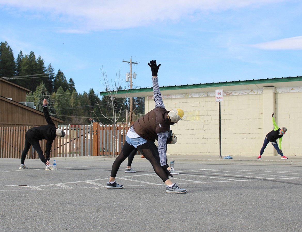 A small group of people have found responsible ways to stay fit and happy while practicing social distancing safety precautions in a downtown Bonners Ferry parking lot.