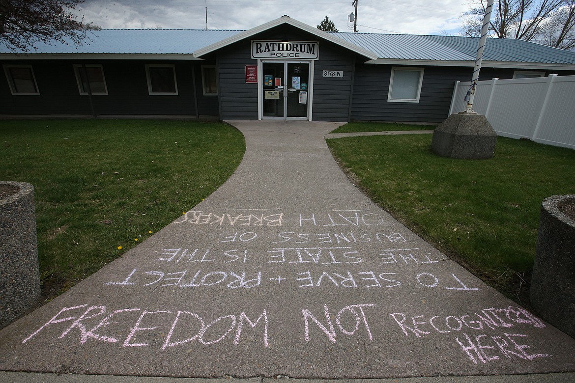 A one-hour protest in front of the Rahdrum Police station resulted in some messages left on the walkway Monday afternoon.