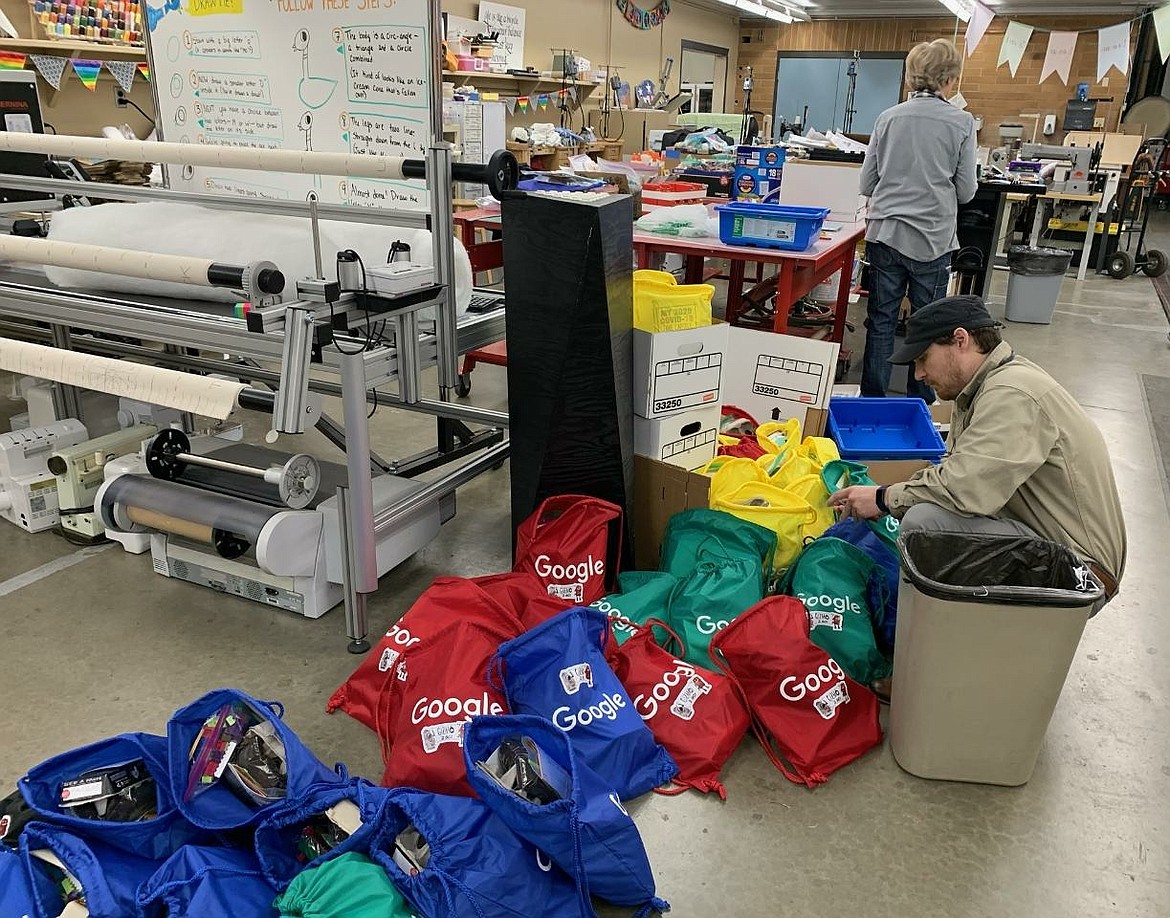 Gizmo-CDA worker Erik Satren on Monday prepares kits of educational yet fun projects that will be delivered today to kids served by North Idaho CASA. (Courtesy photo)