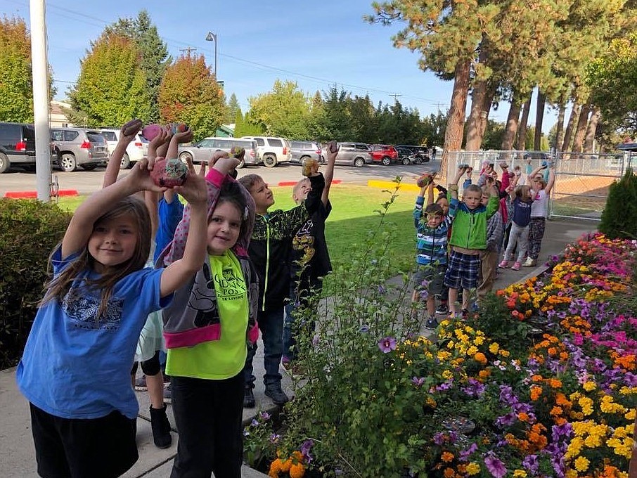 Northwest Expedition Academy (NExA) students show off painted rocks in front of the school last fall. The Hayden community is invited to join NExA and its families for a community-wide scavenger hunt from 4 to 7 p.m. Wednesday, April 29.