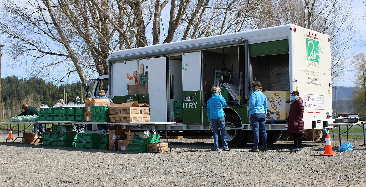 (Photo by TONIA BROOKS) 
 The Second Harvest Inland Empire food delivery truck arrived early Wednesday, April 22 to offload much needed food items to families and individuals who waited in line within their vehicles.