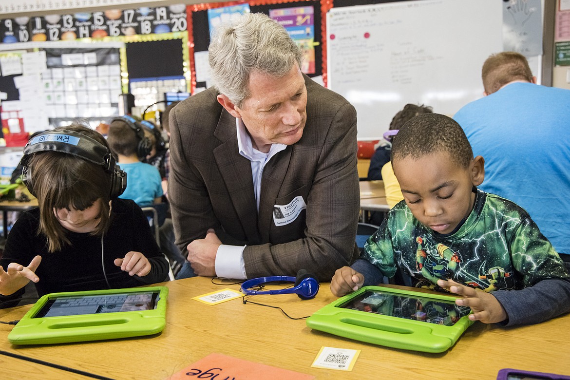 Jay Larsen, founder and CEO of the Idaho Techology Council, works with students during Hour of Code at Garfield Elementary in Boise last December. On Wednesday, Larsen, Gov. Brad Little and project partners announced Idaho Codes, a new program for seventh- through 12th-graders to learn computer coding in a self-paced, online course.